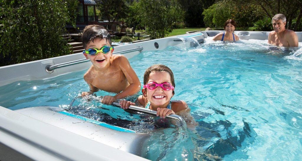 Family with young kids in endless swimming pool