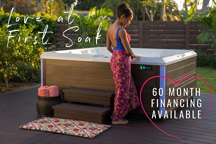 woman standing next to hot tub with text: love at first soak