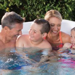 Family of 4 enjoying their swim spa