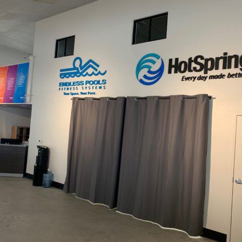 Showroom hot tub logos on wall at Concord Hot Tub Showroom