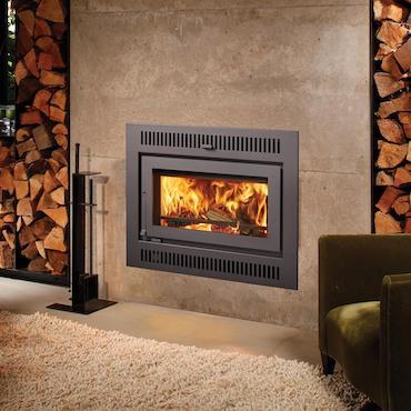 42 Apex™ fireplace wall unit in living area with wood stacks