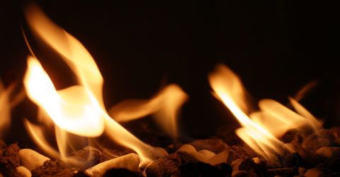 flames from gas fire place over decorative rocks
