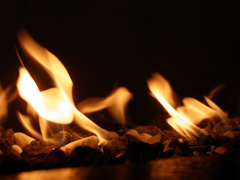 flames from gas fire place over decorative rocks