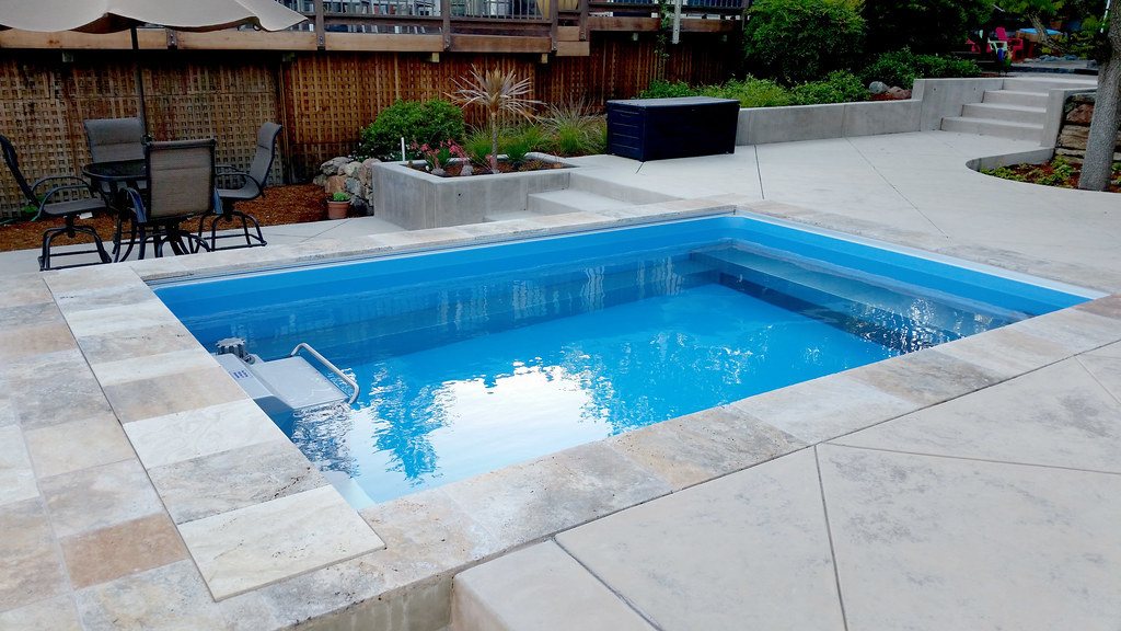 swim spa installed completely in ground in backyard