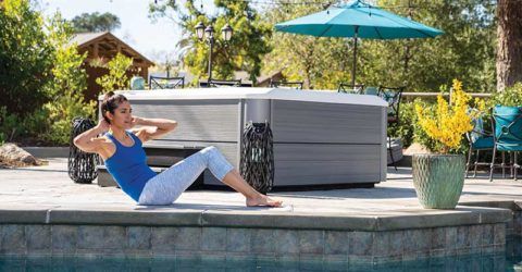 women exercising in her backyard next to her hot tub