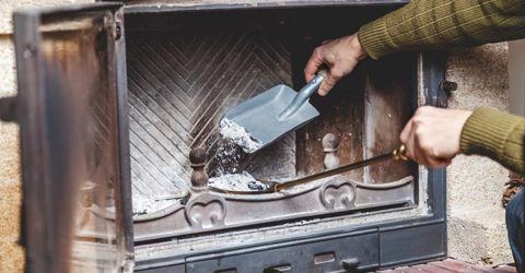 person cleaning a fireplace in springtime