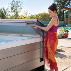 hot tub owner safely removes folding swim spa cover using a hot tub cover lifter