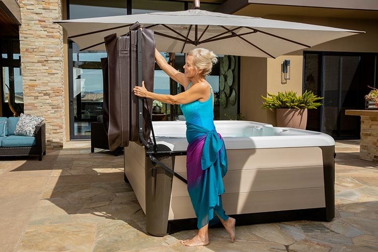 Woman using hydraulic hot tub cover