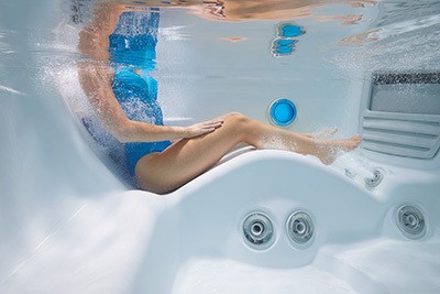 Underwater view of Lounge Seat with woman enjoying massage jets