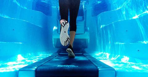 women running underwater on an aquatic treadmill in an Endless Pool Swim Spa