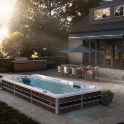 Semi in-ground swim spa with surrounding patio at dusk