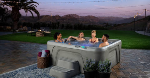 Family and Friends enjoying a hot tub on a Summer evening