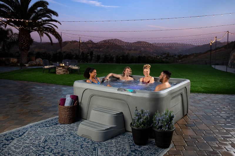 Family and Friends enjoying a hot tub on a Summer evening