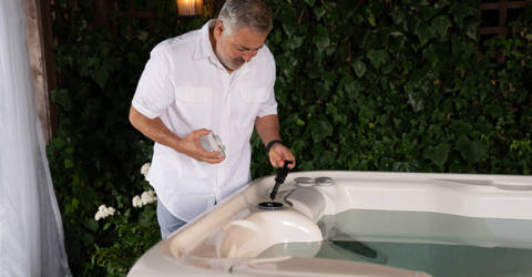Man cleaning his HotSpring Highlife Jetsetter Hot Tub
