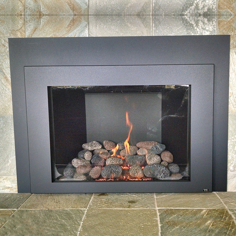 Photo provided by Creative Energy customer: a gas fireplace insert installed in a traditional fireplace mantel