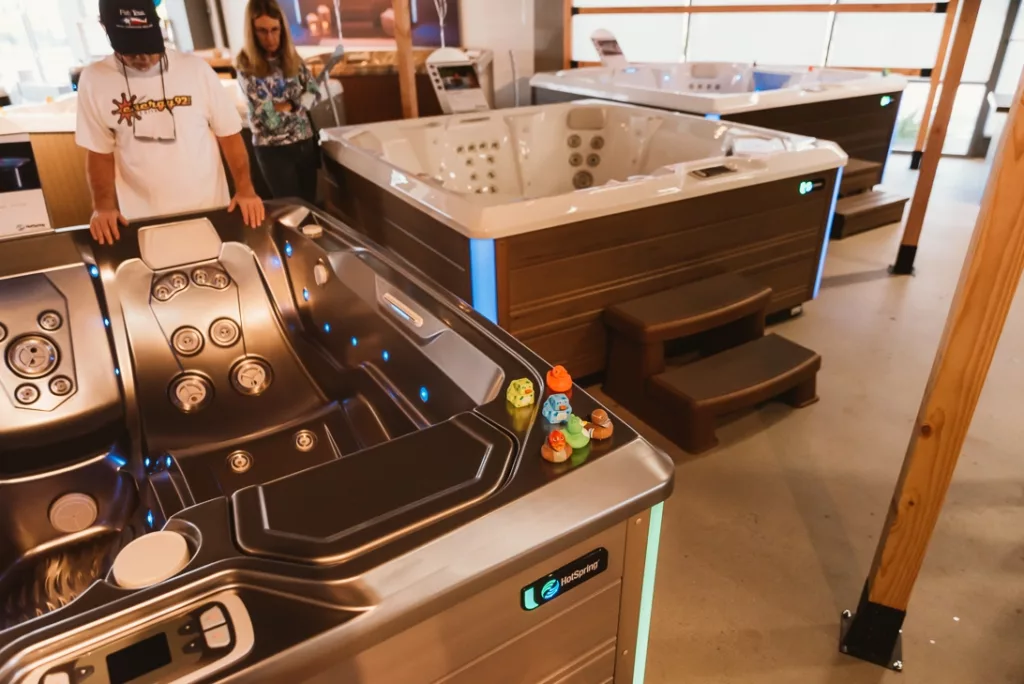 Interior of the Creative Energy San Rafael Showroom featuring two customers looking at a Hot Spring hot tub floor model