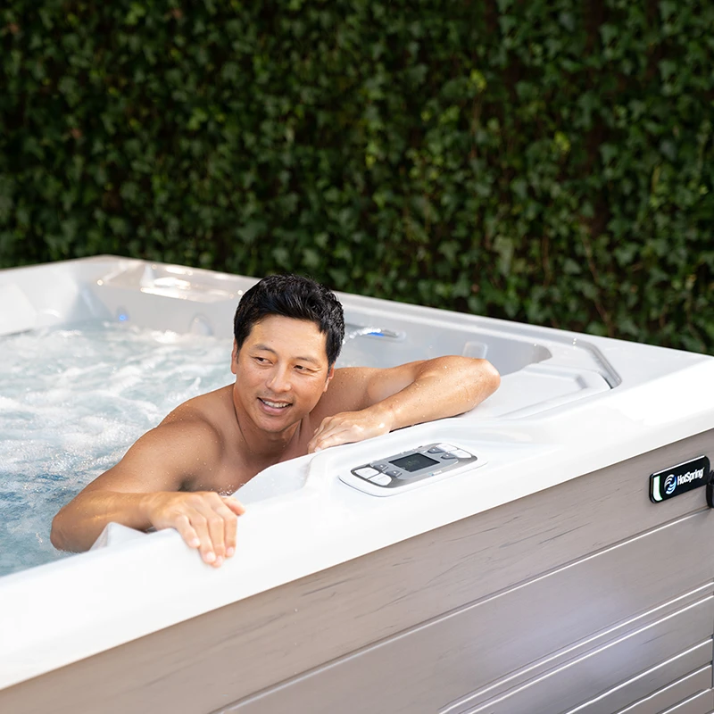 Man relaxing in a HotSpring Limelight Saltwater Hot Tub