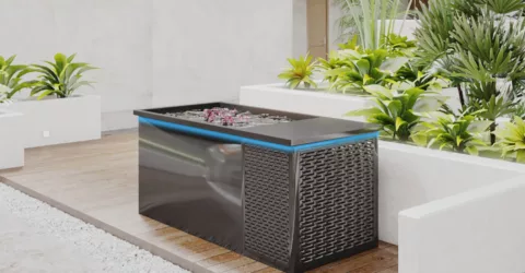 An Arctic Plunge cold plunge tub in a room with white walls, surrounded by plants.