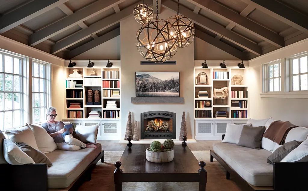 A gas fireplace in a cozy living room, surrounded by bookshelves.