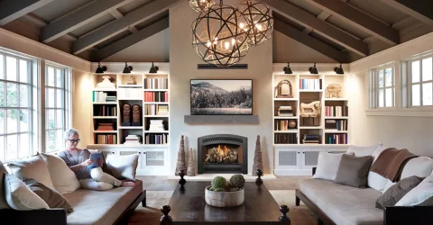 A gas fireplace in a cozy living room, surrounded by bookshelves.