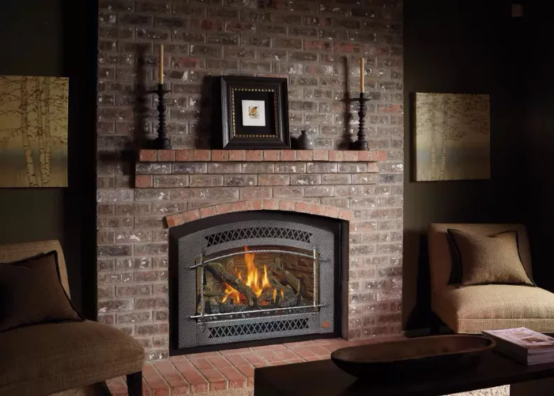 A gas fireplace insert in a brick fireplace.