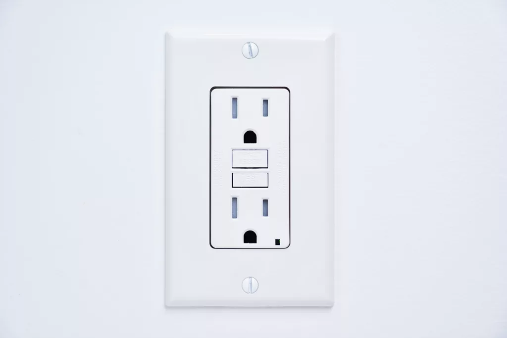 A GFCI outlet on a white wall