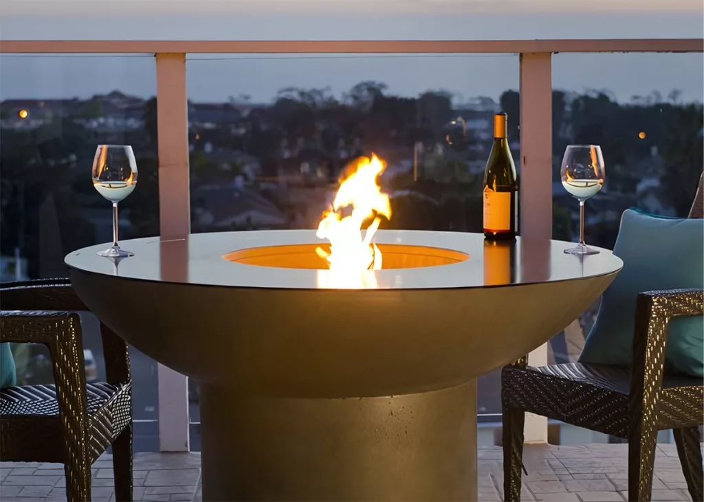 The Lotus Dining Firetable with glasses of wine on a balcony