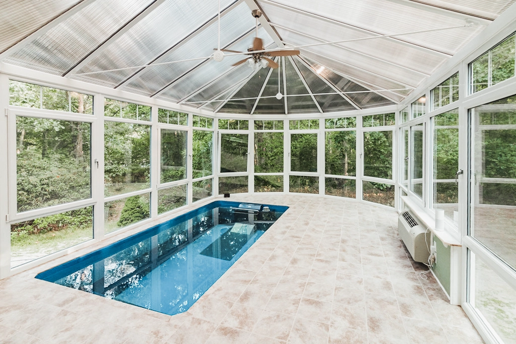 An indoor Endless Pools modular pool installed in a sunroom